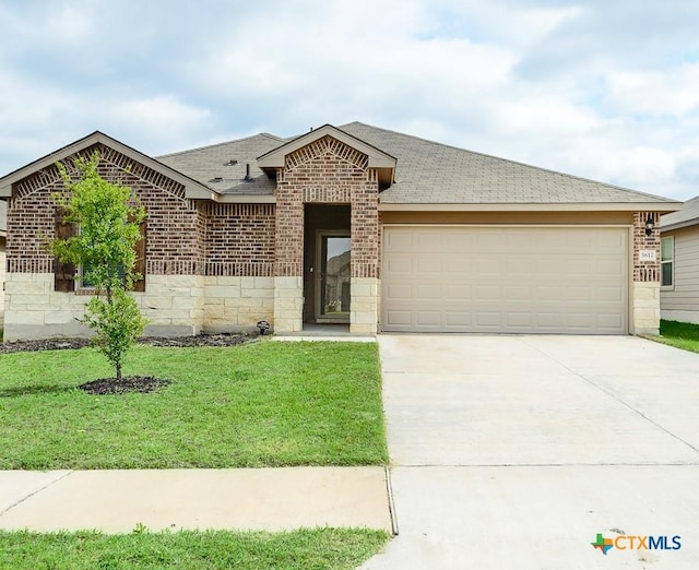 ranch-style house featuring a garage, driveway, a front yard, brick siding, and roof with shingles