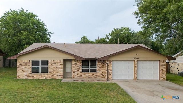 2301 Dover Rd, Killeen, TX 76543 - ranch-style home featuring an attached garage, driveway, a front yard, brick siding, and a shingled roof