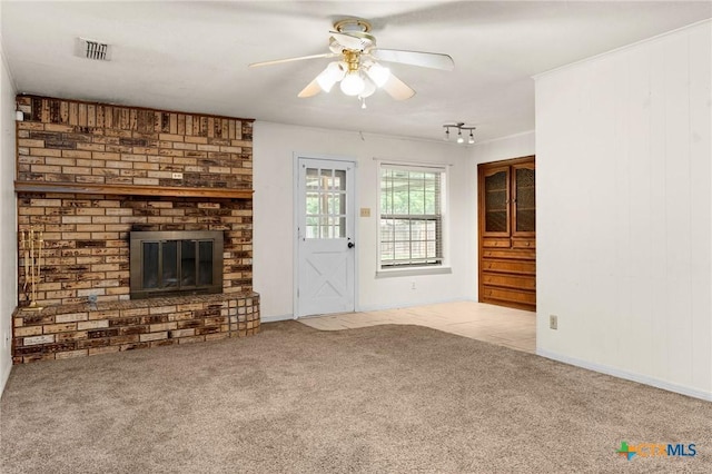 2301 Dover Rd, Killeen, TX 76543 - unfurnished living room featuring carpet flooring, a ceiling fan, and a brick fireplace