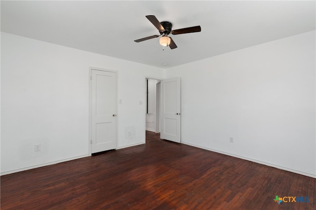 spare room featuring dark hardwood / wood-style flooring and ceiling fan