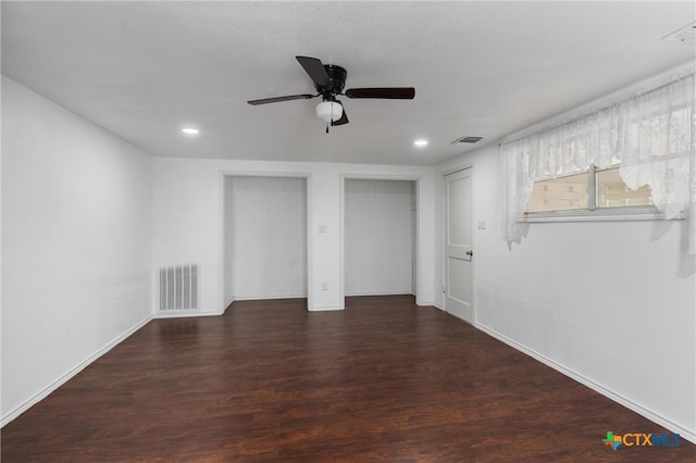 unfurnished room featuring ceiling fan and dark hardwood / wood-style flooring