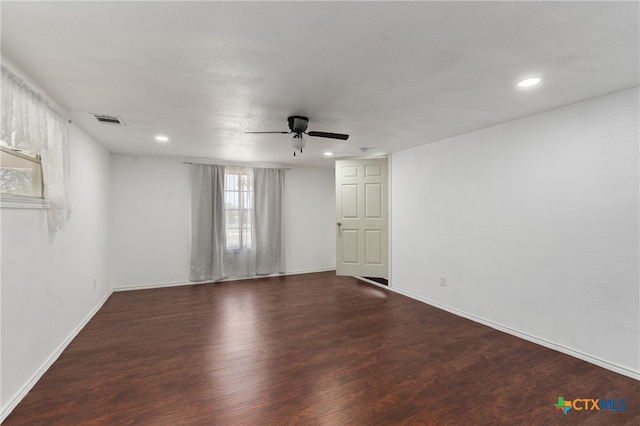 empty room featuring dark wood-type flooring and ceiling fan