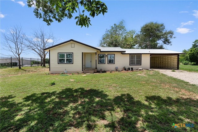 ranch-style house featuring a front lawn and a carport