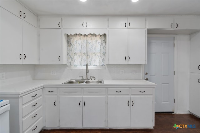 kitchen with sink, dark hardwood / wood-style floors, and white cabinets