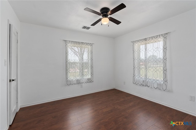 unfurnished room with ceiling fan and dark hardwood / wood-style floors