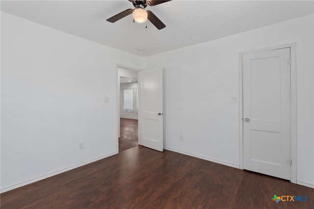 empty room featuring dark hardwood / wood-style floors and ceiling fan