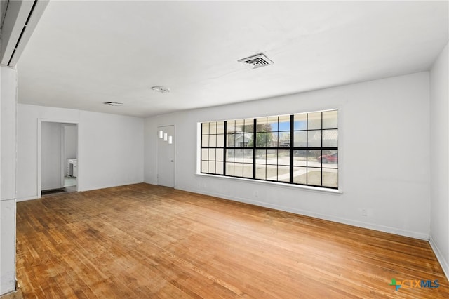 unfurnished room with wood-type flooring