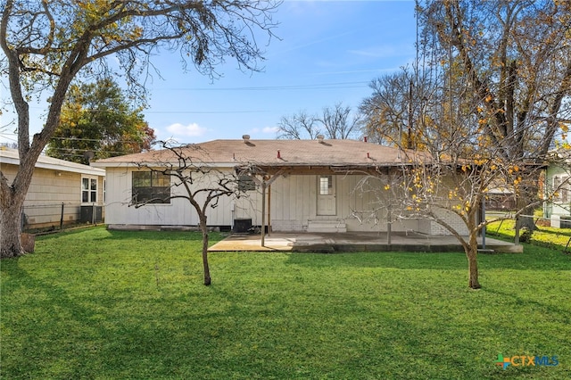 back of house featuring a lawn and a patio area