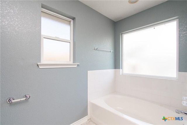 5204 Southern Crossing Dr, Temple, TX 76502 - bathroom featuring a bath and baseboards
