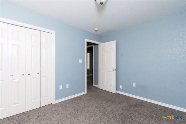 5204 Southern Crossing Dr, Temple, TX 76502 - unfurnished bedroom featuring dark colored carpet, baseboards, and a closet