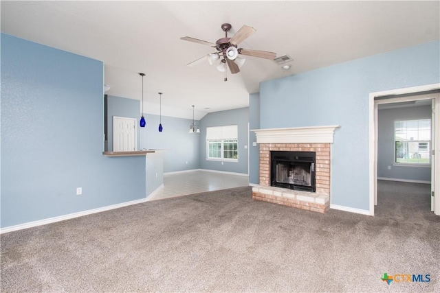 5204 Southern Crossing Dr, Temple, TX 76502 - unfurnished living room featuring carpet flooring, a ceiling fan, a fireplace, baseboards, and lofted ceiling