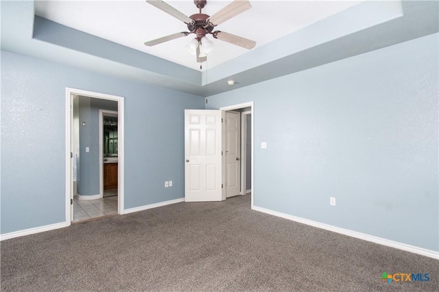 5204 Southern Crossing Dr, Temple, TX 76502 - unfurnished bedroom featuring carpet, a tray ceiling, baseboards, and connected bathroom