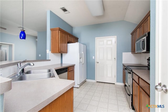 5204 Southern Crossing Dr, Temple, TX 76502 - kitchen featuring appliances with stainless steel finishes, a sink, backsplash, light countertops, and vaulted ceiling