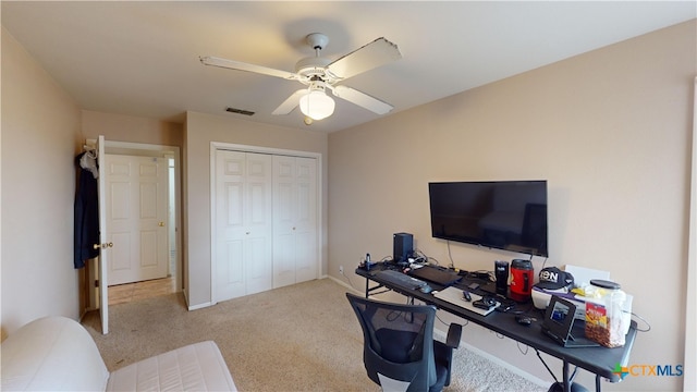 carpeted office with ceiling fan