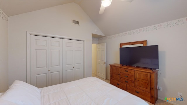 bedroom with ceiling fan, high vaulted ceiling, and a closet