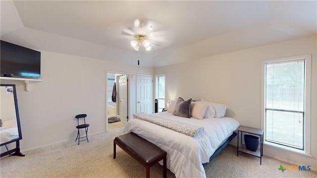 carpeted bedroom featuring ensuite bathroom and ceiling fan