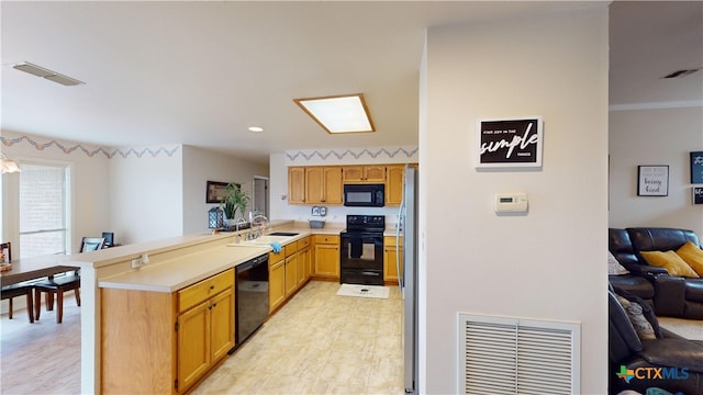 kitchen featuring kitchen peninsula, sink, and black appliances