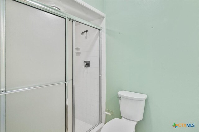6013 Country Club Dr, Victoria, TX 77904 - bathroom featuring toilet and a shower stall