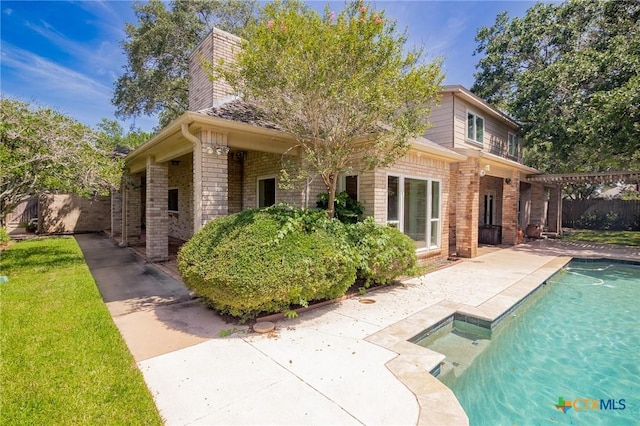 6013 Country Club Dr, Victoria, TX 77904 - back of property with brick siding, a patio, and a chimney