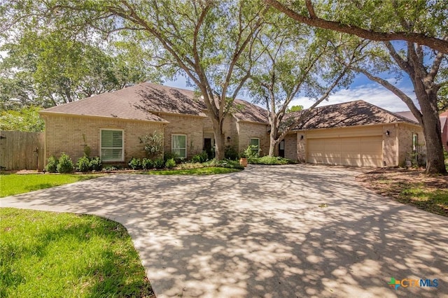 6013 Country Club Dr, Victoria, TX 77904 - view of front facade with brick siding, driveway, and a garage