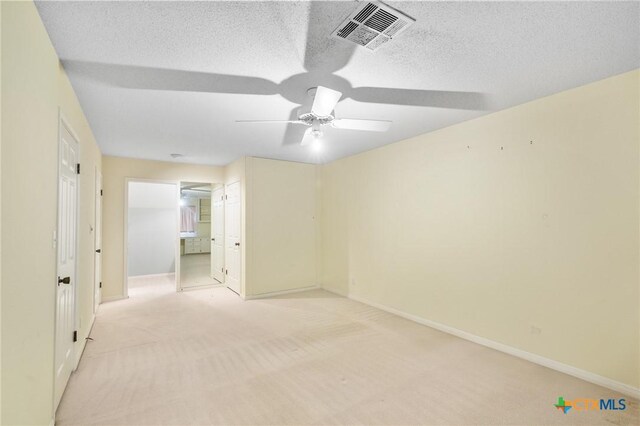 6013 Country Club Dr, Victoria, TX 77904 - unfurnished bedroom featuring light carpet, a textured ceiling, and ceiling fan