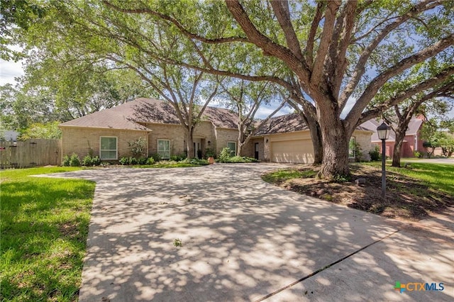 6013 Country Club Dr, Victoria, TX 77904 - view of front of home featuring driveway, brick siding, and an attached garage