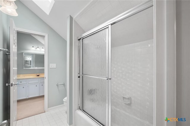 6013 Country Club Dr, Victoria, TX 77904 - bathroom featuring vanity, a skylight, vaulted ceiling, tile patterned flooring, and combined bath / shower with glass door