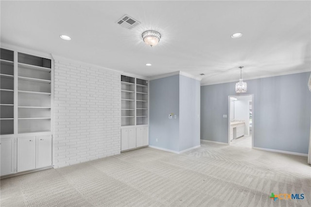 6013 Country Club Dr, Victoria, TX 77904 - empty room with light carpet, built in shelves, brick wall, recessed lighting, and crown molding