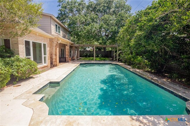 6013 Country Club Dr, Victoria, TX 77904 - view of swimming pool with a pergola, a fenced backyard, and a patio