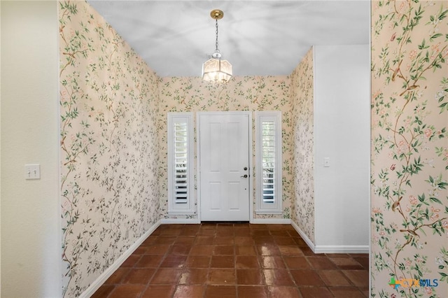 6013 Country Club Dr, Victoria, TX 77904 - tiled entrance foyer with a chandelier and wallpapered walls