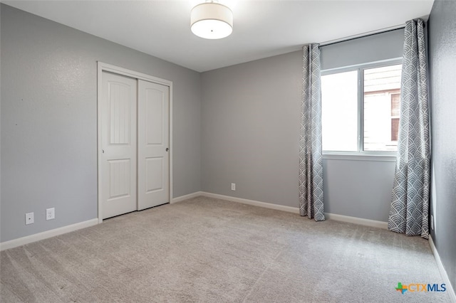 506 Old Peak Rd, Georgetown, TX 78626 - unfurnished bedroom featuring a closet, carpet flooring, and baseboards