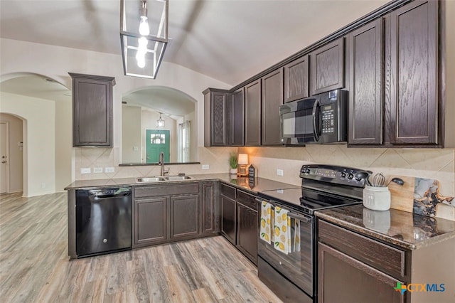 506 Old Peak Rd, Georgetown, TX 78626 - kitchen featuring black appliances, a sink, arched walkways, dark brown cabinets, and lofted ceiling