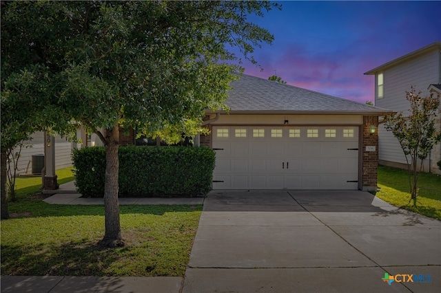 506 Old Peak Rd, Georgetown, TX 78626 - view of front of property featuring driveway, an attached garage, a lawn, and roof with shingles