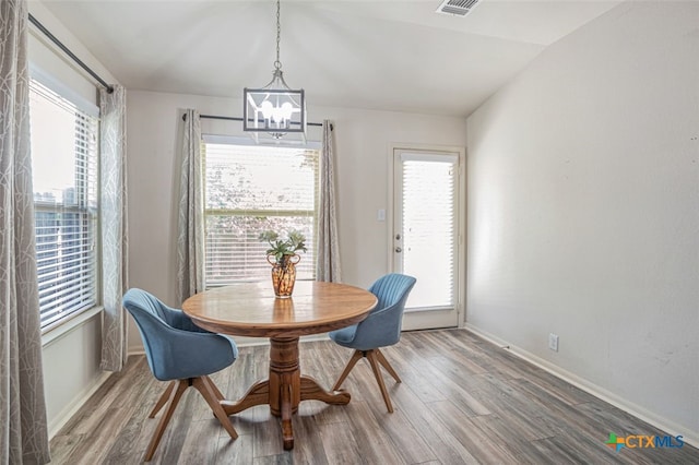 506 Old Peak Rd, Georgetown, TX 78626 - dining area with a chandelier, wood finished floors, baseboards, and lofted ceiling
