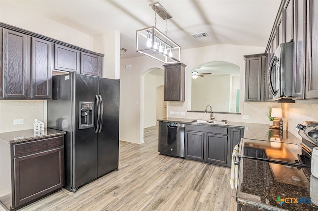 506 Old Peak Rd, Georgetown, TX 78626 - kitchen with black appliances, arched walkways, a sink, lofted ceiling, and decorative backsplash