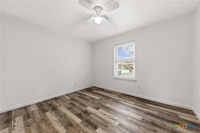 unfurnished room featuring ceiling fan and dark hardwood / wood-style floors