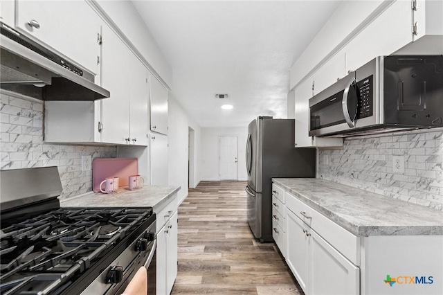 kitchen with white cabinetry, light wood-type flooring, and appliances with stainless steel finishes