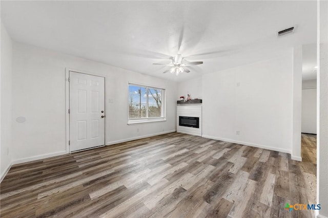 unfurnished living room with ceiling fan and hardwood / wood-style floors