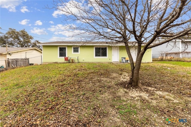 back of house with a lawn