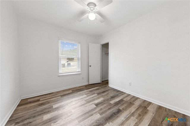 unfurnished room with hardwood / wood-style floors and ceiling fan