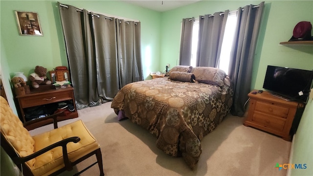 bedroom featuring light carpet