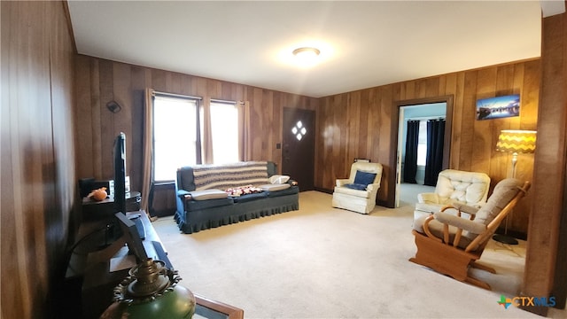 living room with wood walls and light carpet