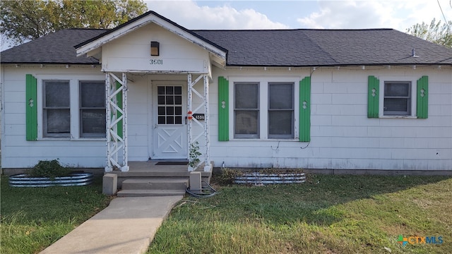 bungalow-style house with a front yard