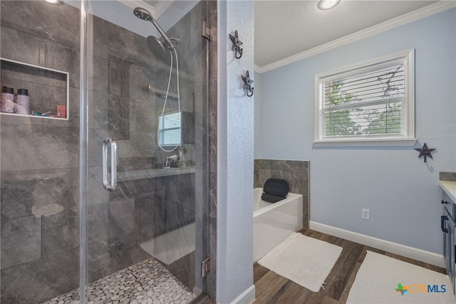 bathroom featuring wood-type flooring, ornamental molding, independent shower and bath, and a textured ceiling