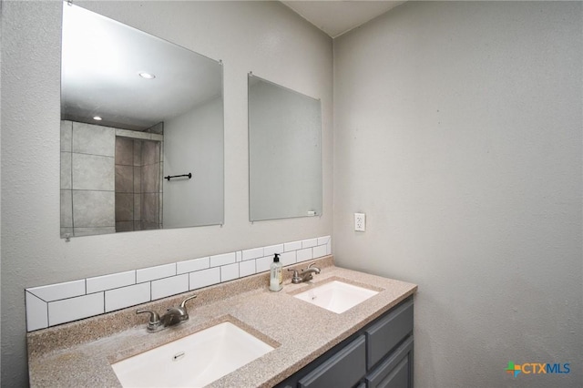 bathroom with vanity and decorative backsplash