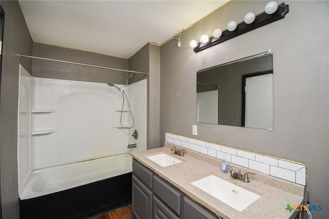 bathroom featuring bathing tub / shower combination, backsplash, and vanity