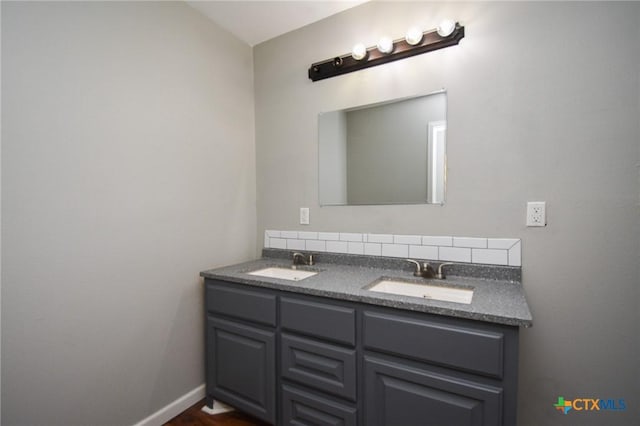 bathroom with vanity and tasteful backsplash