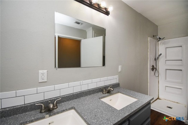 bathroom featuring vanity and a shower