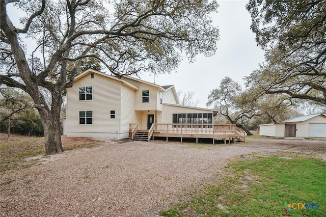 back of house with a deck and a sunroom