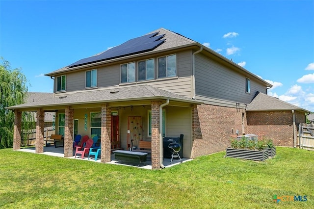 2502 Dante Ct, Harker Heights, TX 76548 - rear view of house with a patio area, roof mounted solar panels, brick siding, an outdoor living space, and a garden